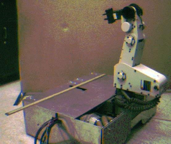 A picture of a mobile robot with a Mitsubishi arm